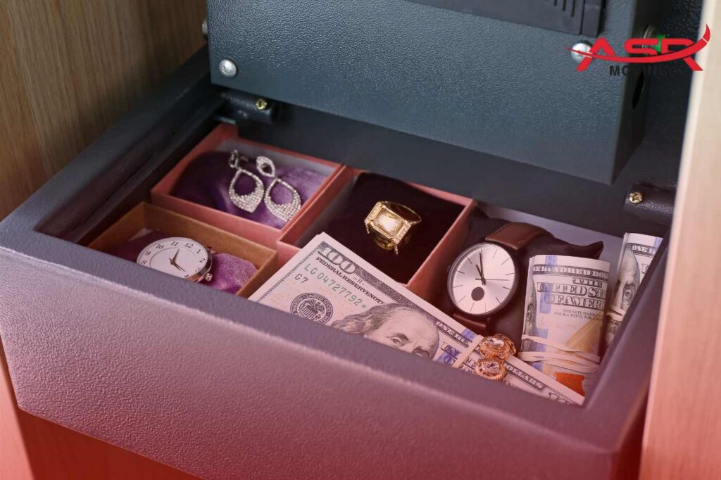 Open safe containing jewelry, cash, and valuables
