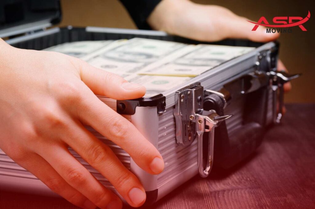 Close-up of money in a lockbox representing the high cost of moving and budgeting needs.