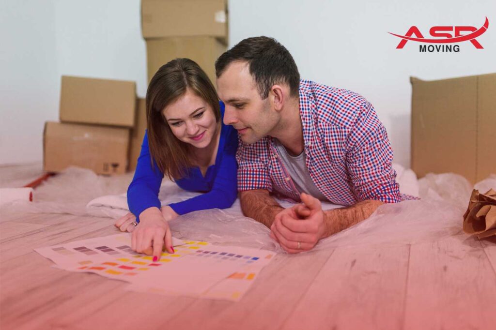 Couple planning their cross-country move, reviewing documents and organizing their moving checklist at home