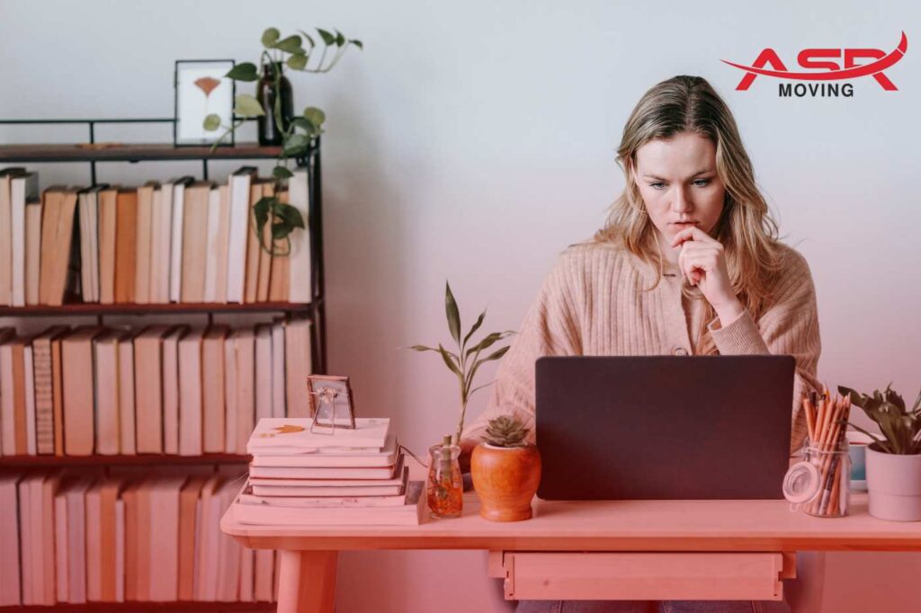Woman researching moving costs and planning budget on a laptop at home.