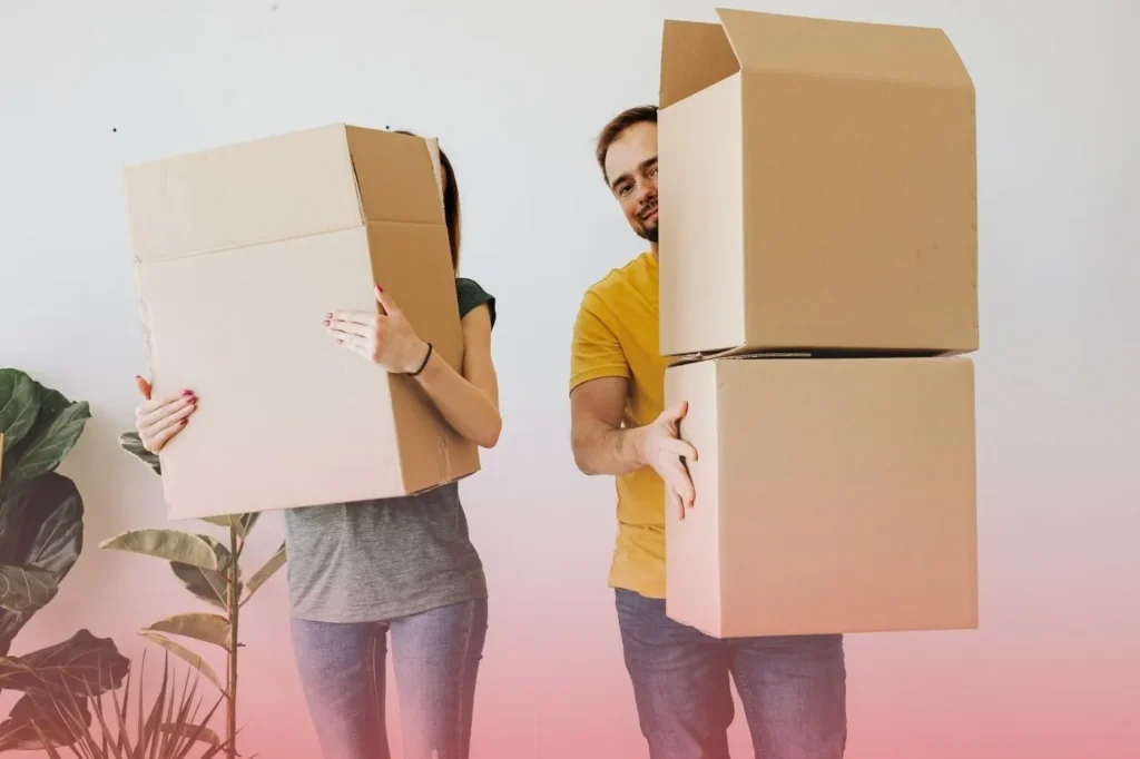 a  husband and wife both holding a box