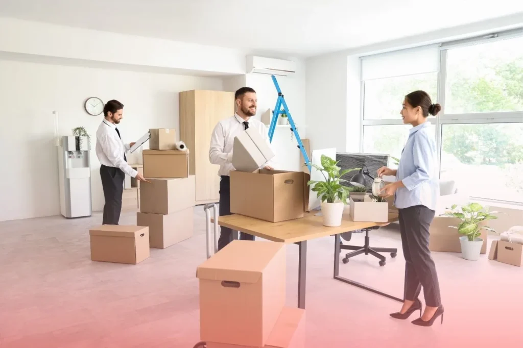 an office workers packing and putting their things on the box
