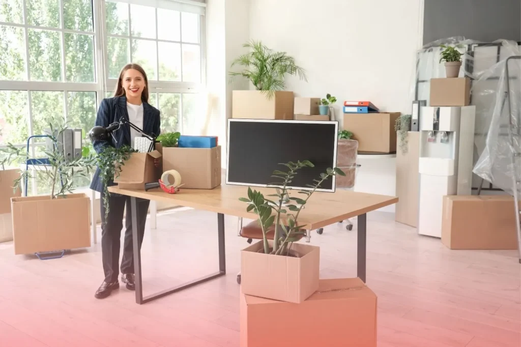 a woman standing beside a desk